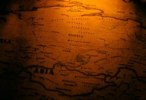 Close-up of an antiqued map highlighting Russia in a warm sepia tone.