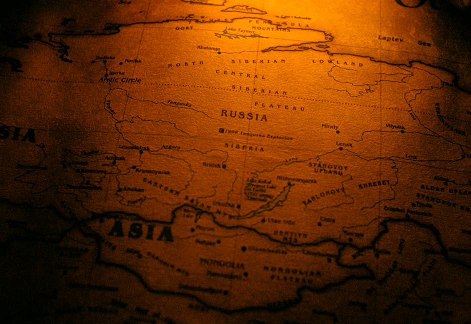 Close-up of an antiqued map highlighting Russia in a warm sepia tone.